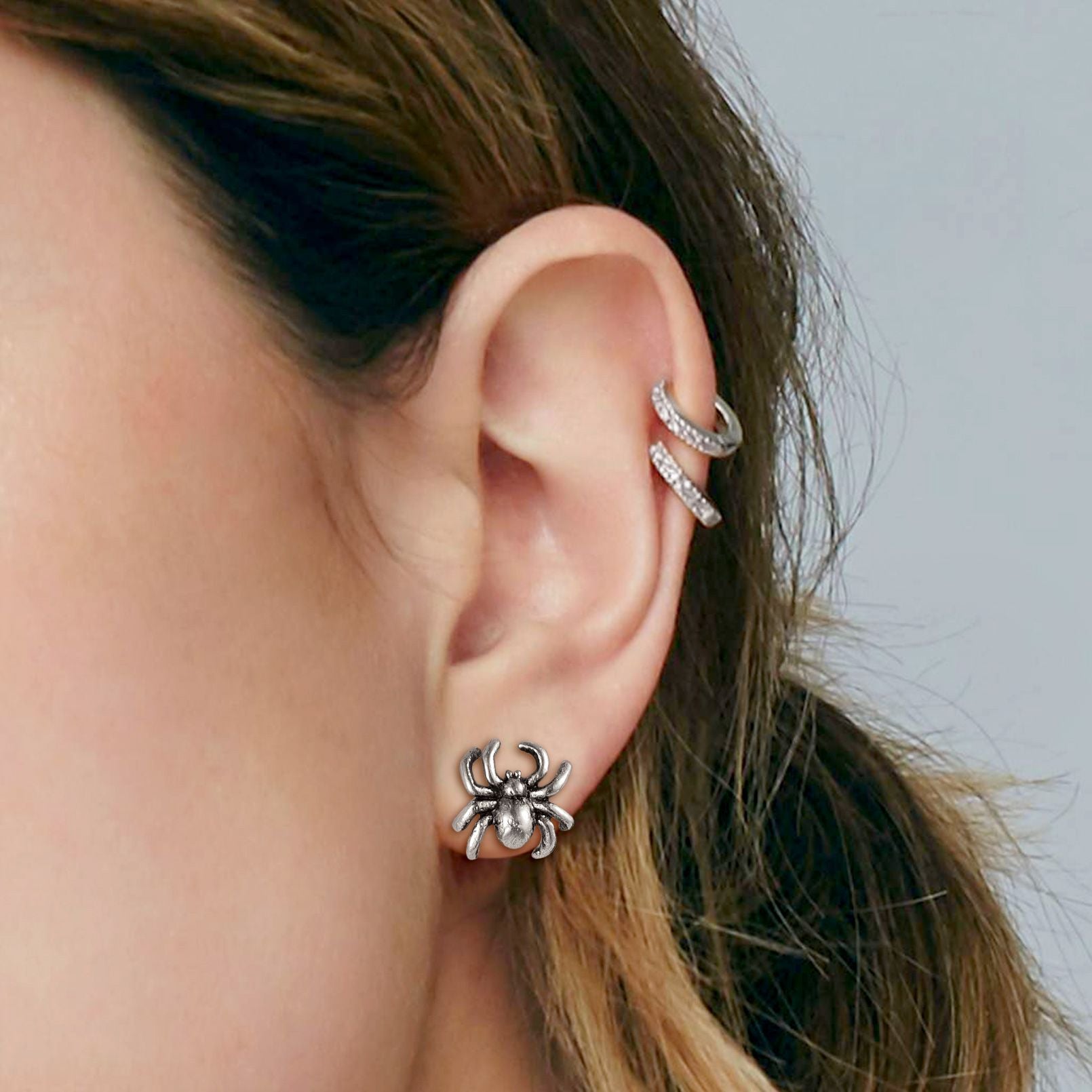 A Woman Wearing Stainless Steel Spider Stud Earrings