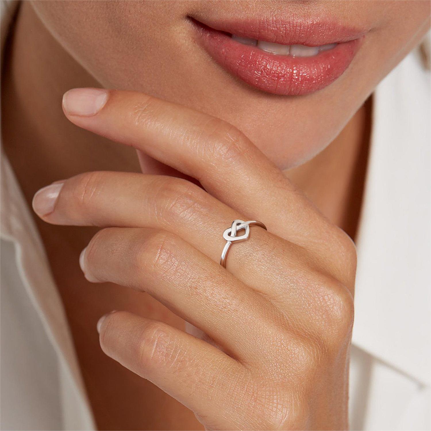 A Woman Wearing Sterling Silver Heart Love Knot Promise Ring