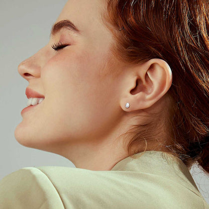 A Woman Wearing Sterling Silver Pear Cut CZ Earrings