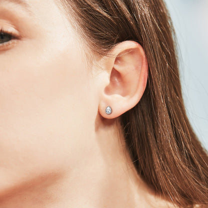 A Woman Wearing Sterling Silver Pear Cut CZ Stud Earrings