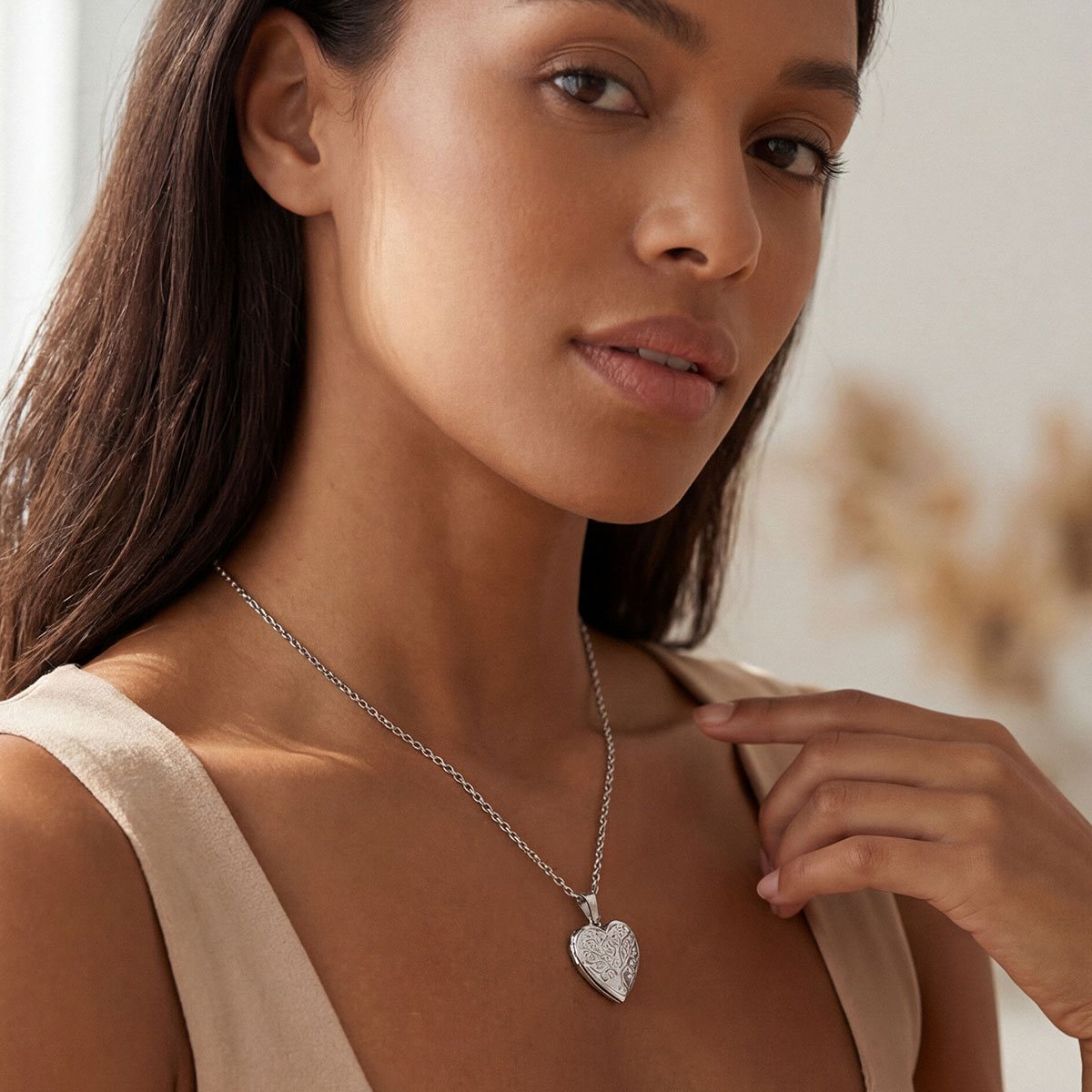 A Woman Wearing Tree of Life Hearts Locket Necklace with Pictures