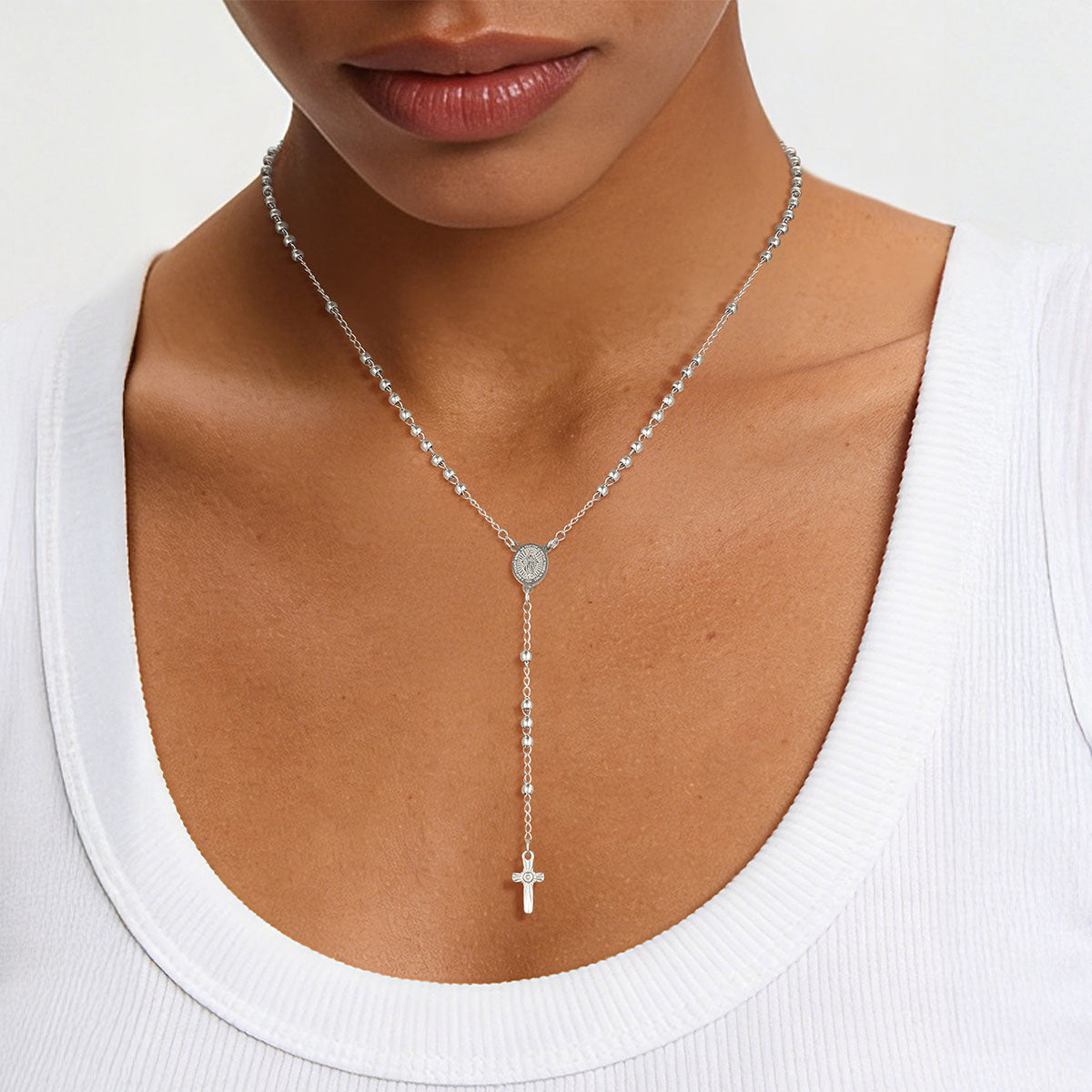 A Woman Wearing Virgin Mary Rosary Beads Cross Necklace