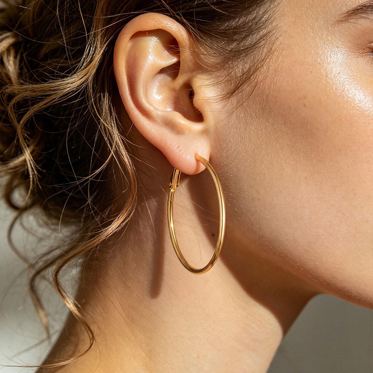 A Woman wearing Gold Classic Statement Hoop Earrings for Women on the white background