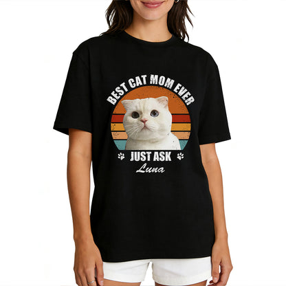 A Woman wearing a black custom pet t-shirt with a cat graphic and text.