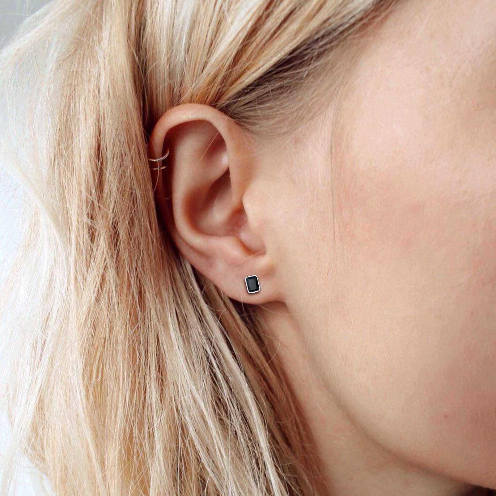 A Women Wearing Sterling Silver Emerald Cut CZ Stud Earrings