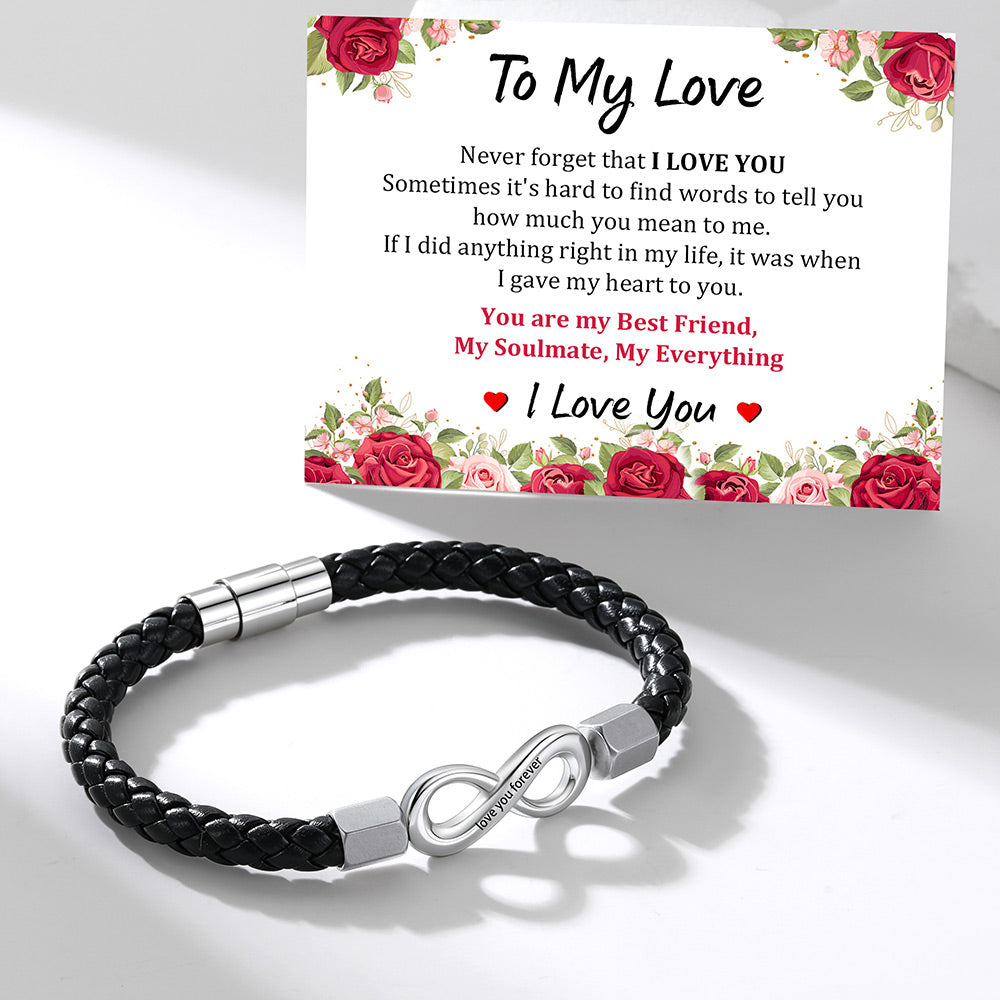A black braided infinity bracelet with a silver infinity clasp is displayed in front of a matching floral 'To My Love' message card on a clean white background.