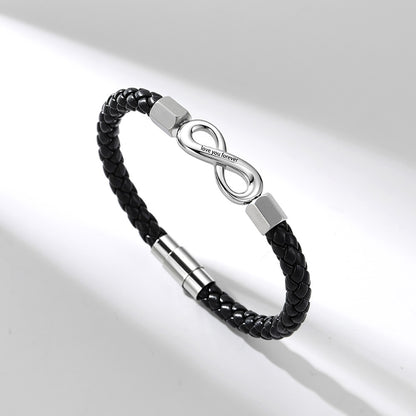 A black braided leather infinity bracelet with a polished silver infinity symbol clasp engraved with 'LOVE YOU BROTHER', shown on a clean white background with soft diagonal shadows.