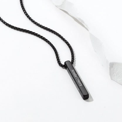 A blackengraved bar necklace with a slim black metal bar pendant engraved with 'Armen of History' in white lettering, displayed on a clean white background with a piece of crumpled paper.