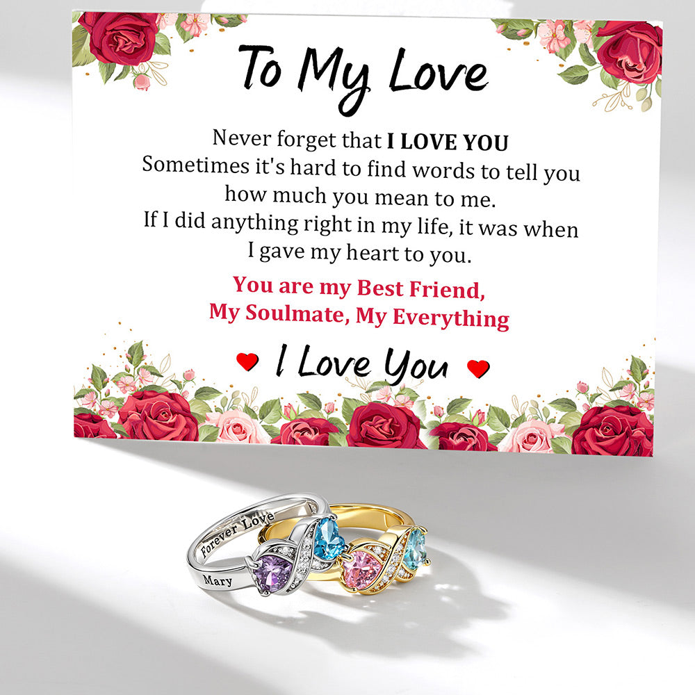 A floral sympathy card with a romantic message to a loved one, shown above two infinity birthstone rings. The card has red rose borders and the text 'To My Love' and 'I Love You' in black and red lettering.