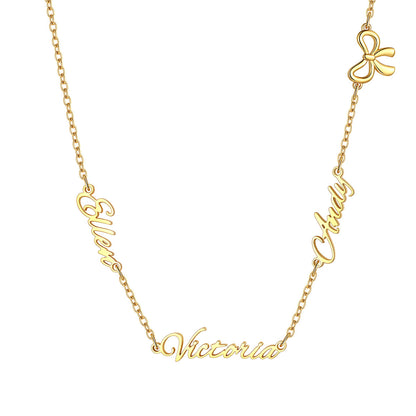 A gold chain custom three name necklace featuring personalized script nameplates spelling 'Elven', 'Clody', and 'Victoria', along with a small bow charm at the top right, shown on a plain white background.