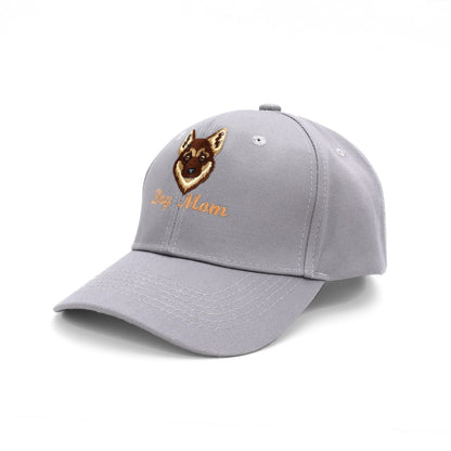 A light gray dog cat baseball cap featuring an embroidered German Shepherd dog face and the text 'Dog Mom' in orange on the front panel, set against a plain white background.