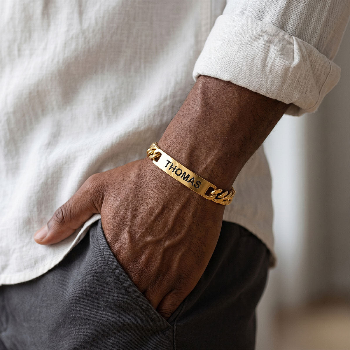 A man Wearing Custom Engraved Text Bar Chain Bracelet Gold Plated
