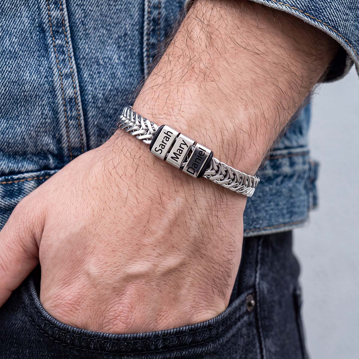 A man in a blue jacket wearing Custom 1-5 Names Chain Bracelet for Men