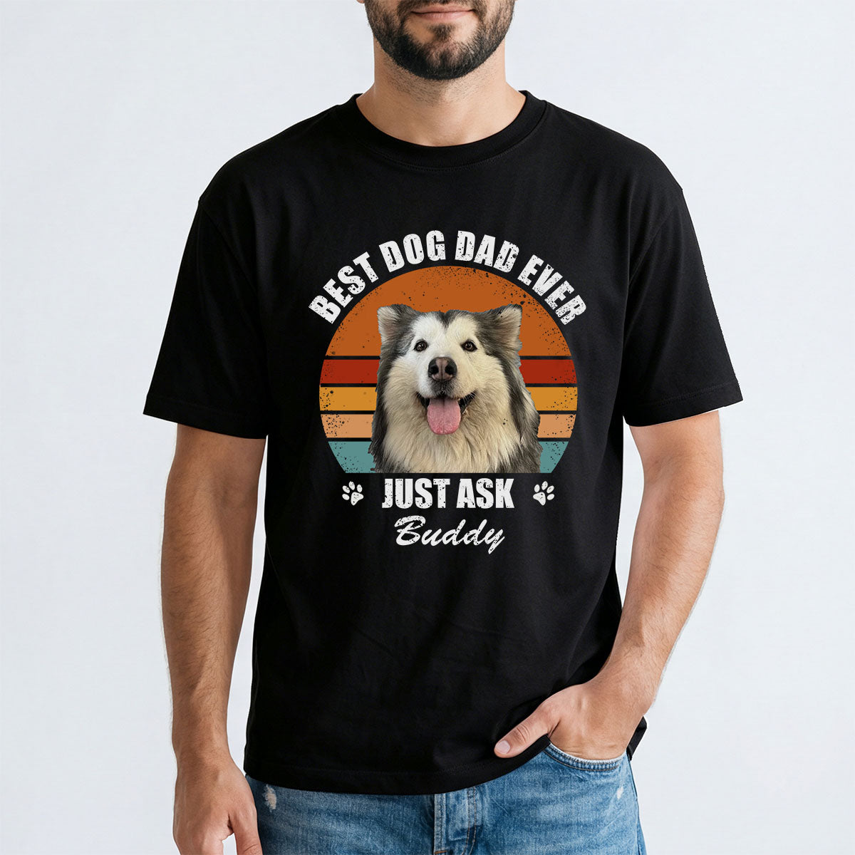A man wearing a black custom dog t-shirt with a cat graphic and text.
