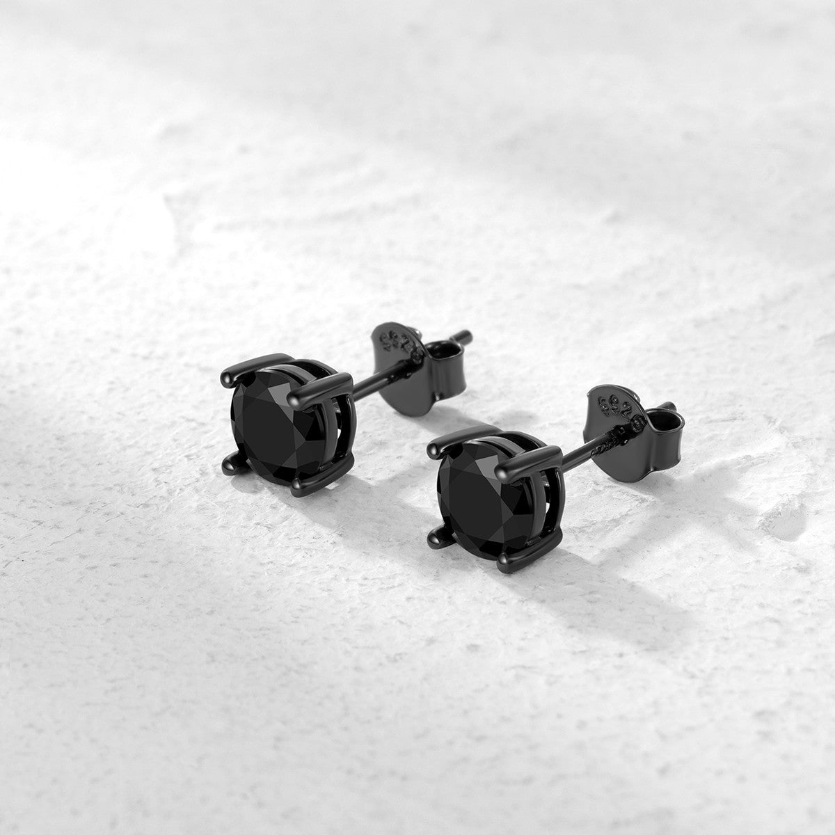 A pair of black CZ Stud Earrings on a white background