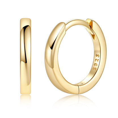 A pair of polished yellow gold huggie hoop earrings shown on a clean white background, with one earring viewed from the side and the other from the front showing a 925 sterling silver hallmark.
