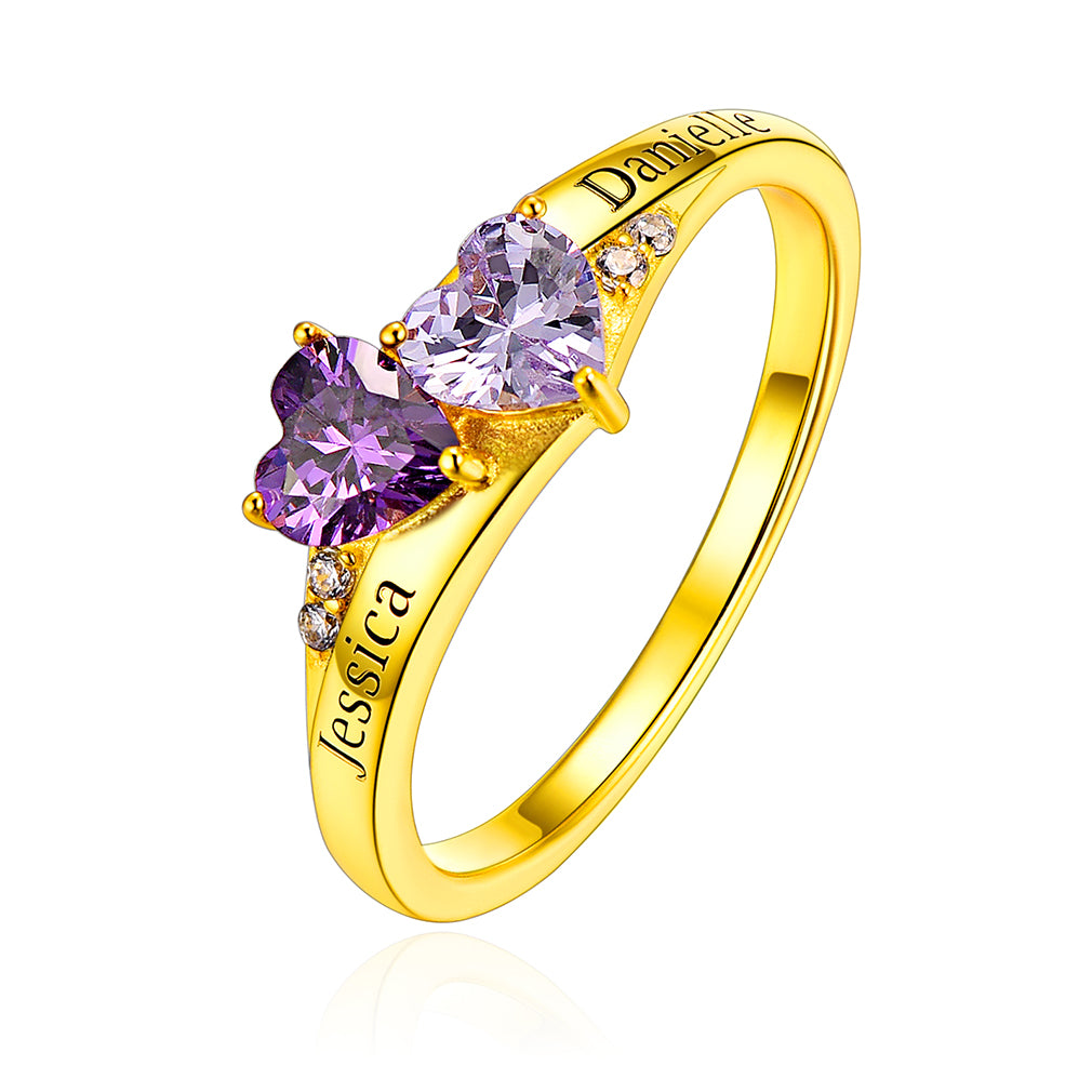 A personalized 2 birthstone ring for women, featuring a heart-shaped purple stone and custom engraving on the band.