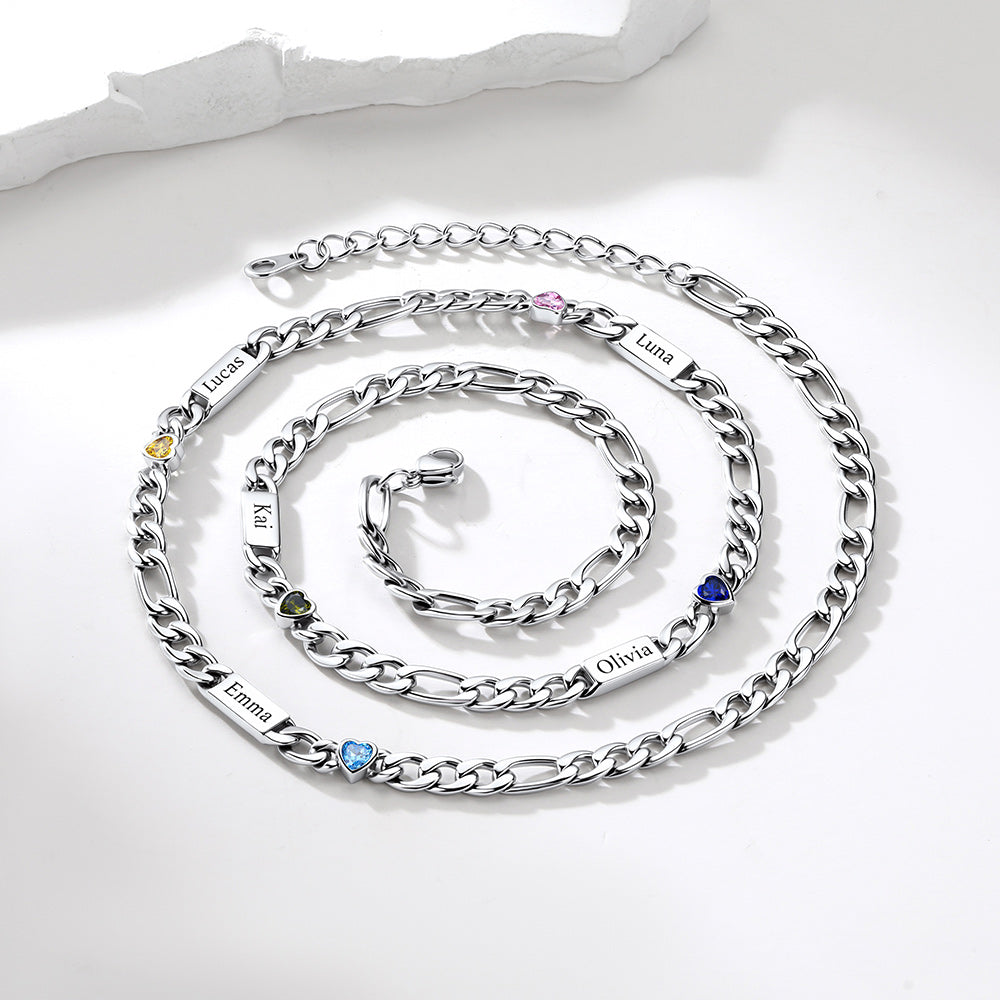 A silver-tone personalized chain necklace arranged in a spiral on a white surface. The necklace features multiple engraved name plates, including Emma, Olivia, Alex, Laura, and Noah, each accented with a small round gemstone in yellow, green, blue, pink, and purple.