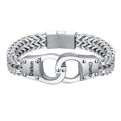 A silver-toned stainless steel bracelet featuring a braided chain design and interlocking handcuff clasp details engraved with the names 'Dalton' and 'Charity'.