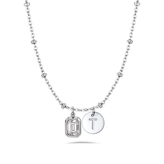 A silver birthstone initial necklace featuring a beaded chain, a rectangular bezel-set clear gemstone charm, and a round engraved silver disc charm with the letter 'T', shown on a clean white background.