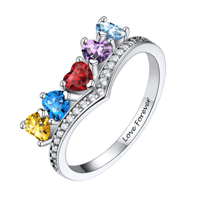 A silver birthstone ring featuring five heart-shaped colored gemstones in yellow, blue, red, purple, and light blue, accented by clear stones along the band, with 'Love Forever' engraved inside. Shown on a plain white background.