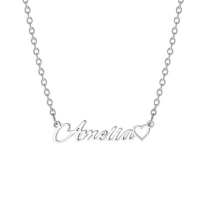A silver chain necklace featuring a personalized script nameplate that reads 'Amelia' in cursive, with a small heart outline at the end of the word, shown on a plain white background.