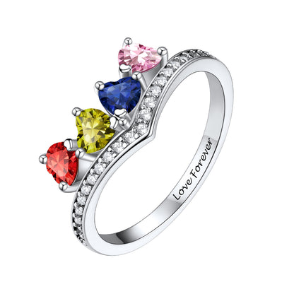 A silver heart-shaped birthstone ring featuring five colorful heart-shaped gemstones in red, yellow, blue, and pink, accented by small clear stones along the band, with 'Love Forever' engraved inside. Shown on a solid white background.