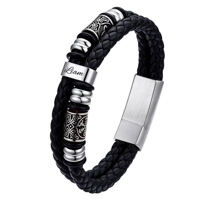 Black braided leather bracelet with silver metal elements on a white background