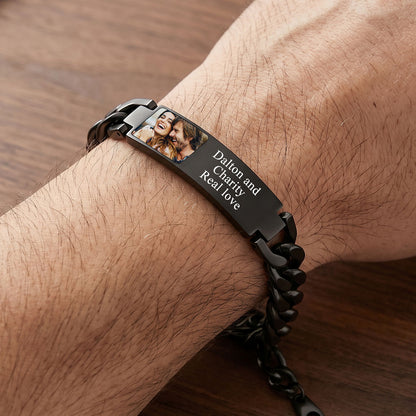 Black custom photo cubanlink bracelet with a photo and text on a wrist against a wooden background
