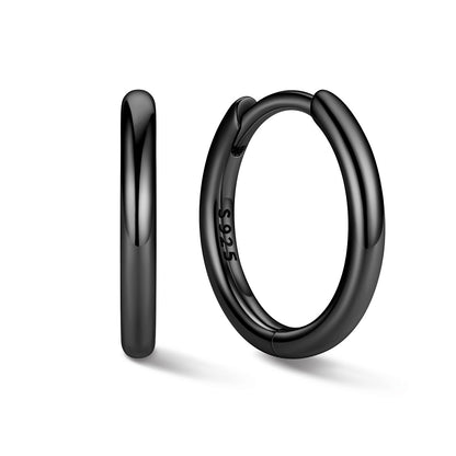 Black huggie earrings on a white background