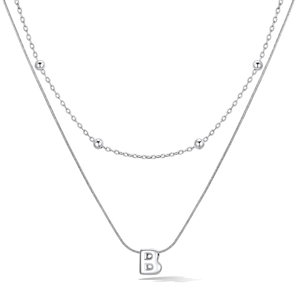 Silver layered initial B necklace, showing measurements and material details.