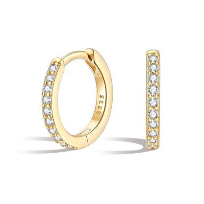 CZ Gold huggie earrings with diamond accents on a white background