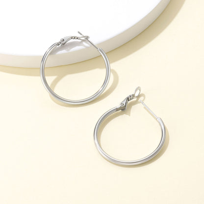 Classic Statement Hoop Earrings for Women on a ligth yellow background