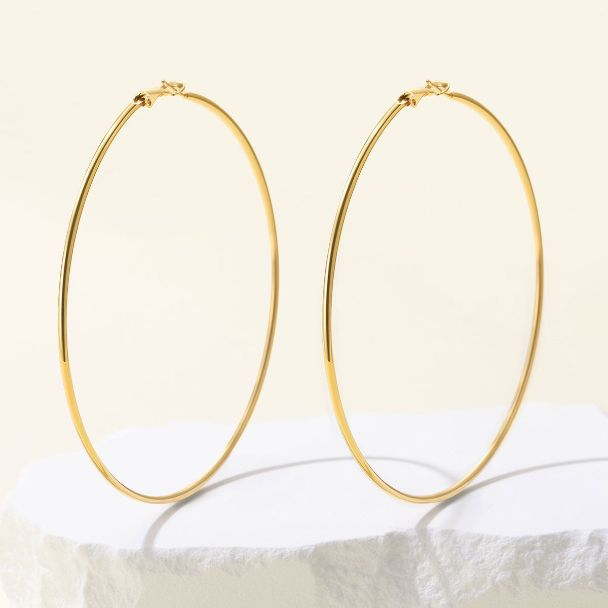 Classic Statement Hoop Earrings for Women on a yellow background