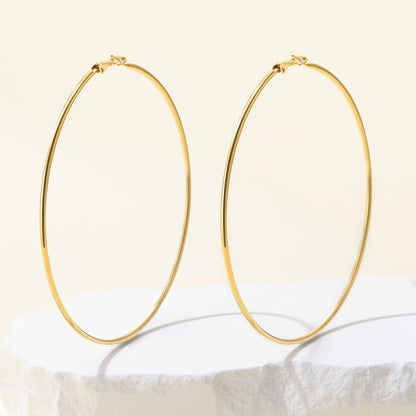 Classic Statement Hoop Earrings for Women on a yellow background