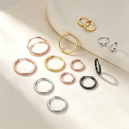 Collection of hoop earrings in various colors on a light background