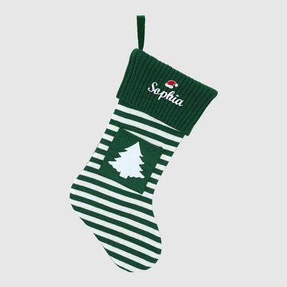 Green Personalized Embroidered Name Striped Christmas Stocking with Holiday Decor handing on a white background