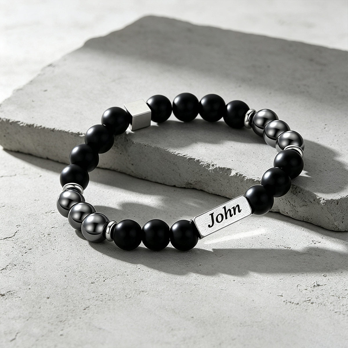 Custom Magnetic Hematite Beaded Bracelet on a cement background