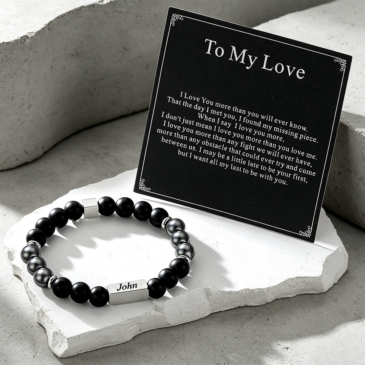Custom Magnetic Hematite Beaded Bracelet on a cement background with greeting card