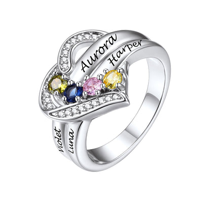 A silver birthstone heart ring featuring a heart-shaped design with custom engraving. The top of the heart is adorned with small clear crystals and three larger colored gemstones in yellow, blue, and pink.