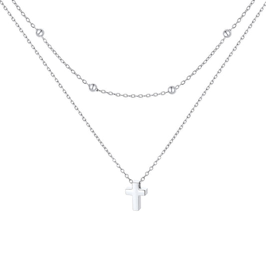 Silver layered cross necklace on a white background