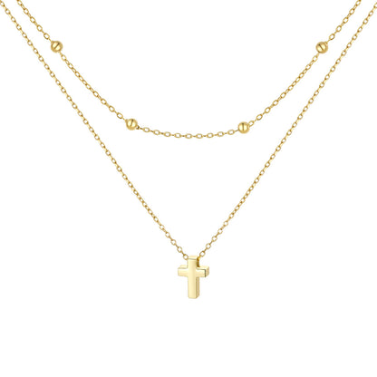 Gold cross necklace on a white background