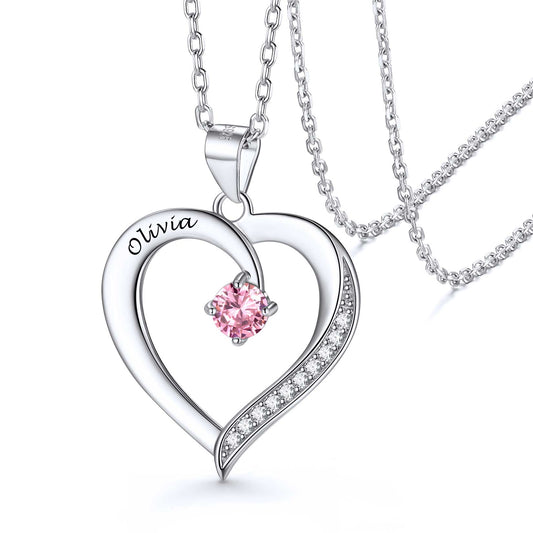 A heart silver birthstone necklace pendant with a birthstones and engraved names on it, attached to a silver chain.