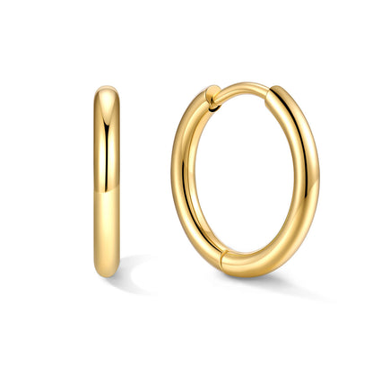 Gold 12mm huggie earrings on a white background