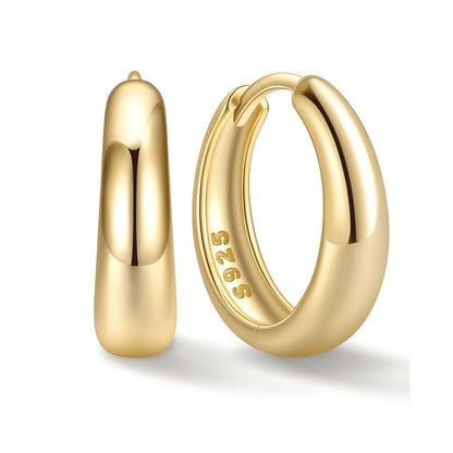 Gold 14mm Chunky huggie earrings on a white background