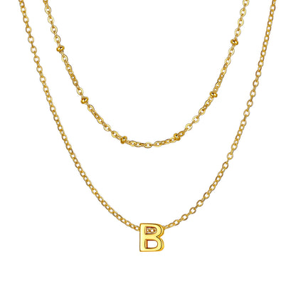Gold Layered initial B necklace on a white background