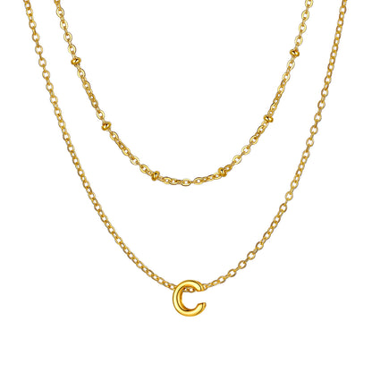Gold Layered initial C necklace on a white background