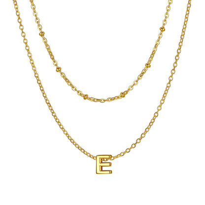 Gold Layered initial E necklace on a white background
