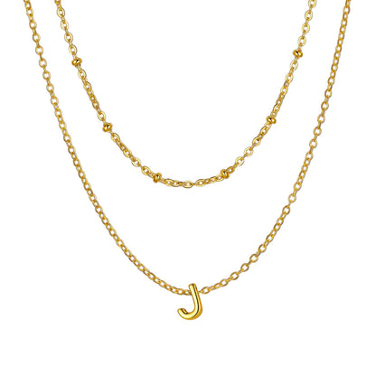 Gold Layered initial J necklace on a white background