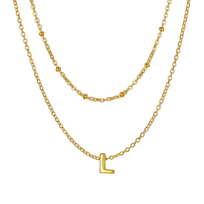 Gold Layered initial L necklace on a white background
